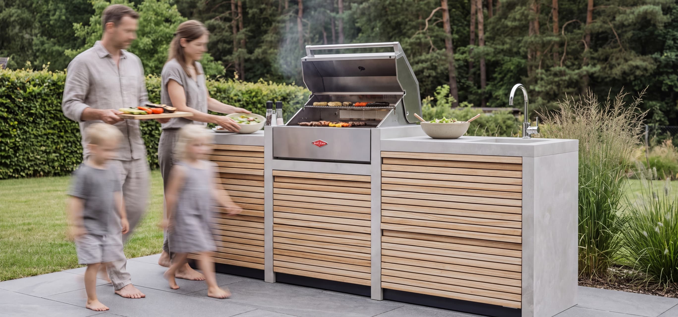 Family cooking together at the RA Beton outdoor kitchen
